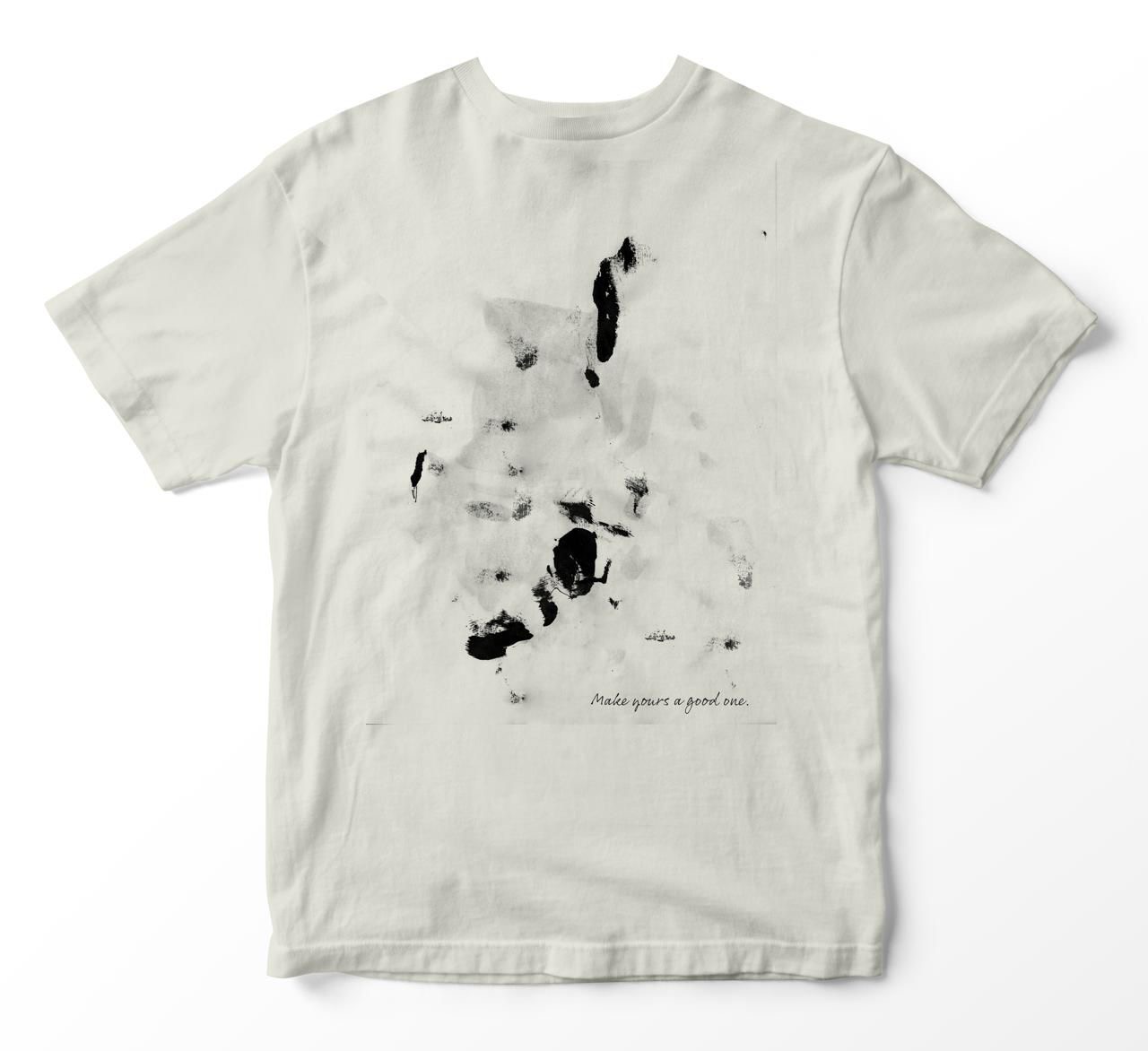 Back of the shirt with abstract black ink marks and the handwritten line “Make yours a good one.”